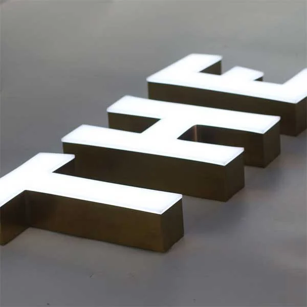 Close-up of white acrylic faces and metal returns on trimless letters — visual reference
